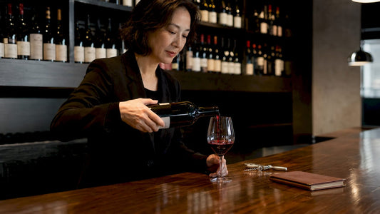 Sommelier pouring Vintage Port in cellar