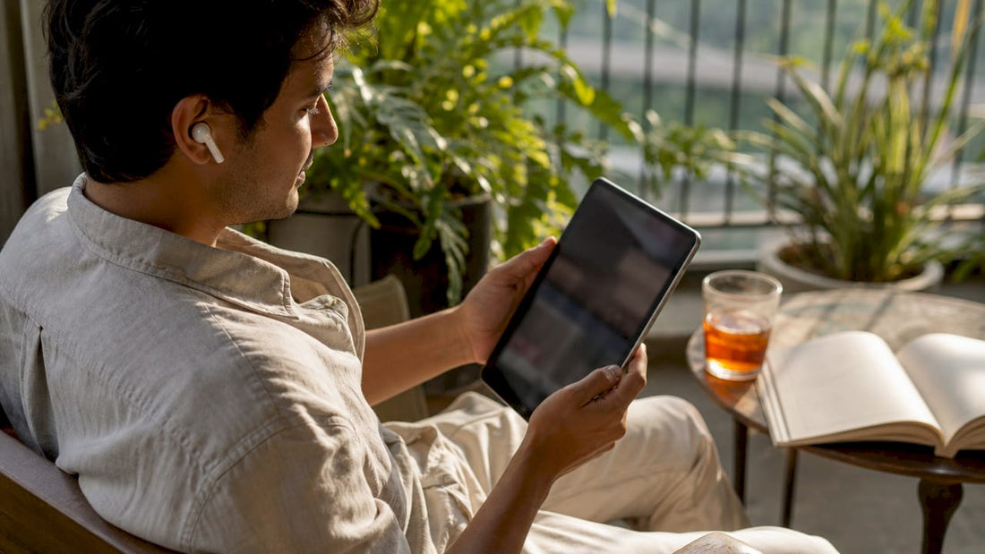 User browsing social networking apps on tablet in café