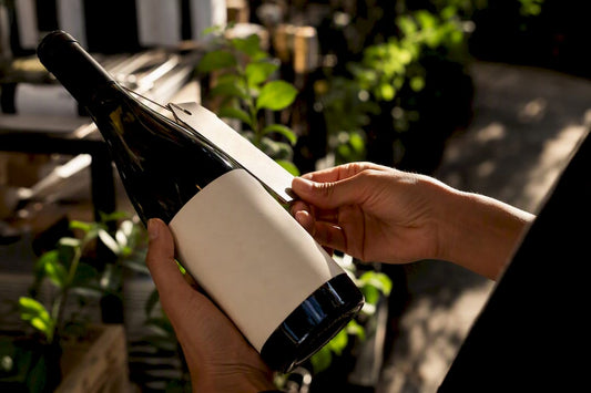 Hands inspecting wine label and price
